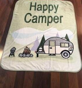 Picnic blanket with a cartoon campsite and the words, "Happy Camper"