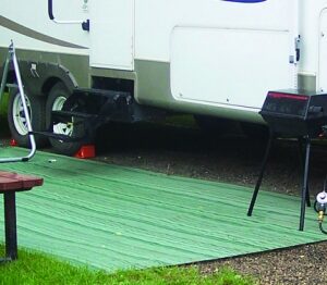 Outdoor awning mat set up in front of a tailer