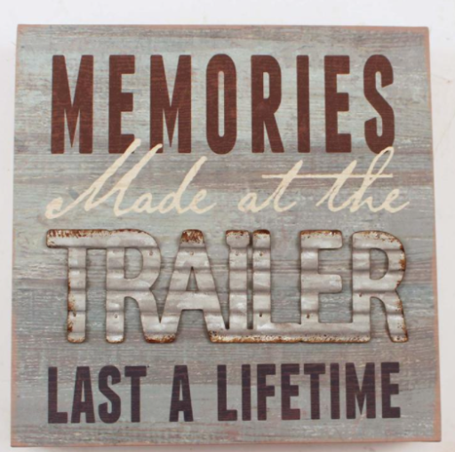 Distressed wood and metal sign saying "Memories made at the trailer last a lifetime"