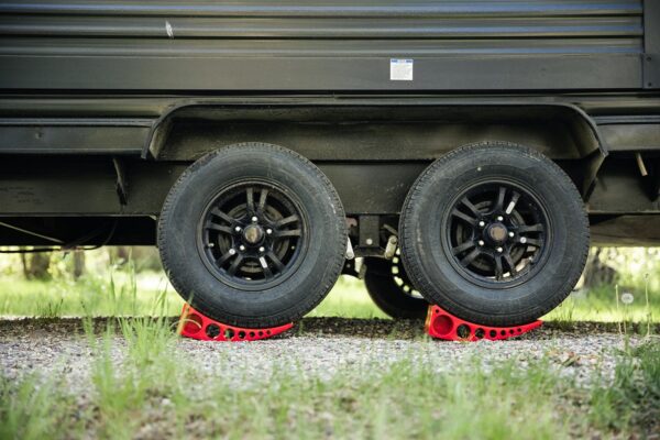 Closeup of trailer wheels having driven up a pair of Andersen levelers.